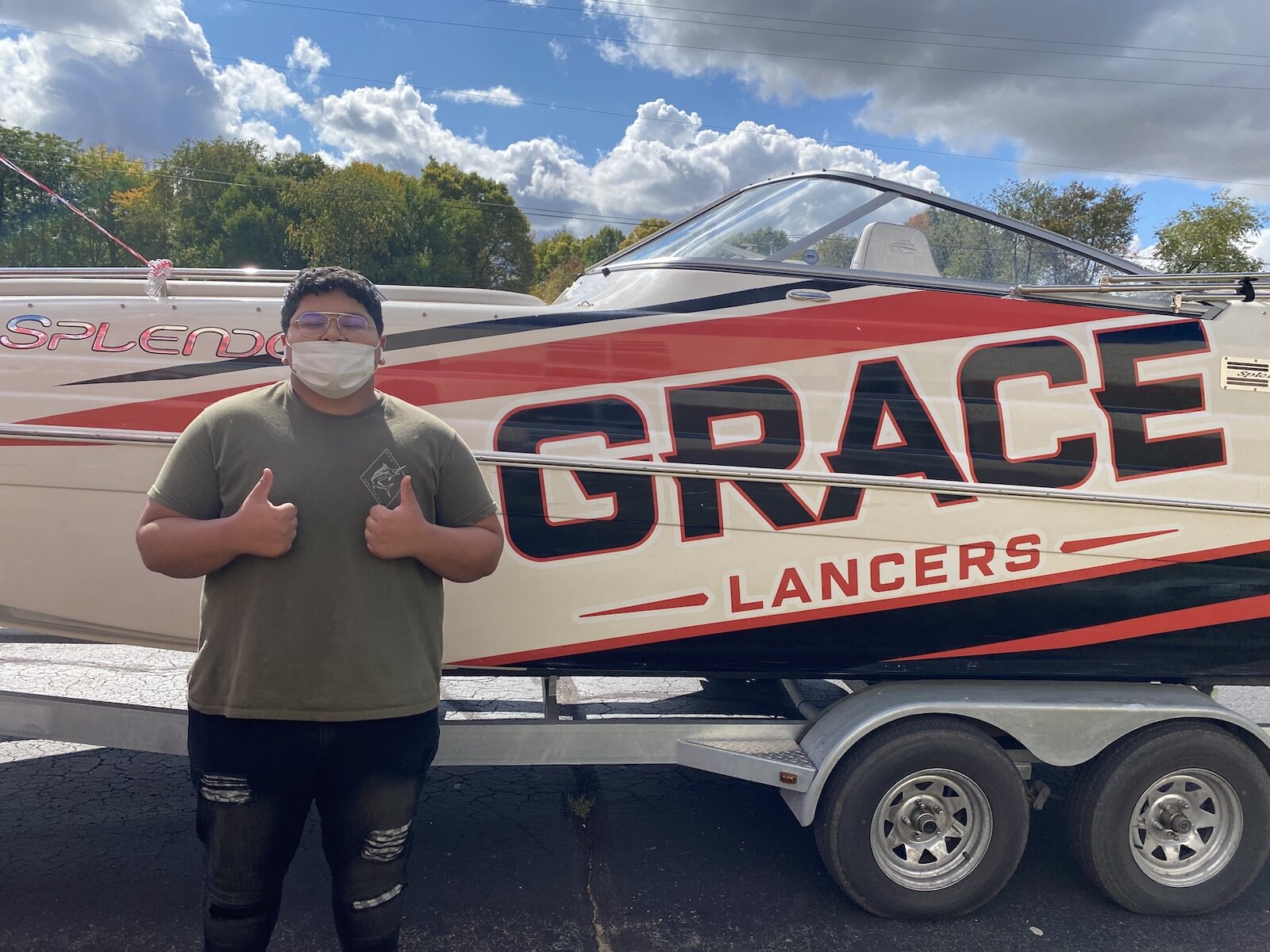 Prospective students get a photo with the Grace College boat.