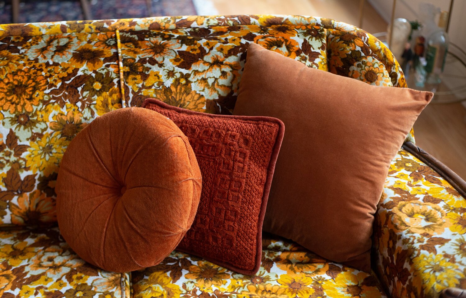Monochromatic pillows add texture to a vintage sofa.