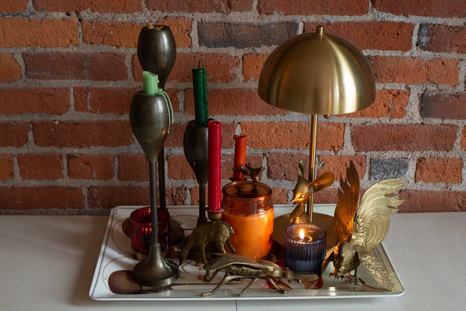 Lamps and candles create an eclectic centerpiece.