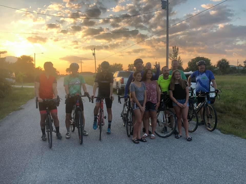 Riders in the Andrew Shipley Memorial Ride pose with Shipley's wife and two daughters.