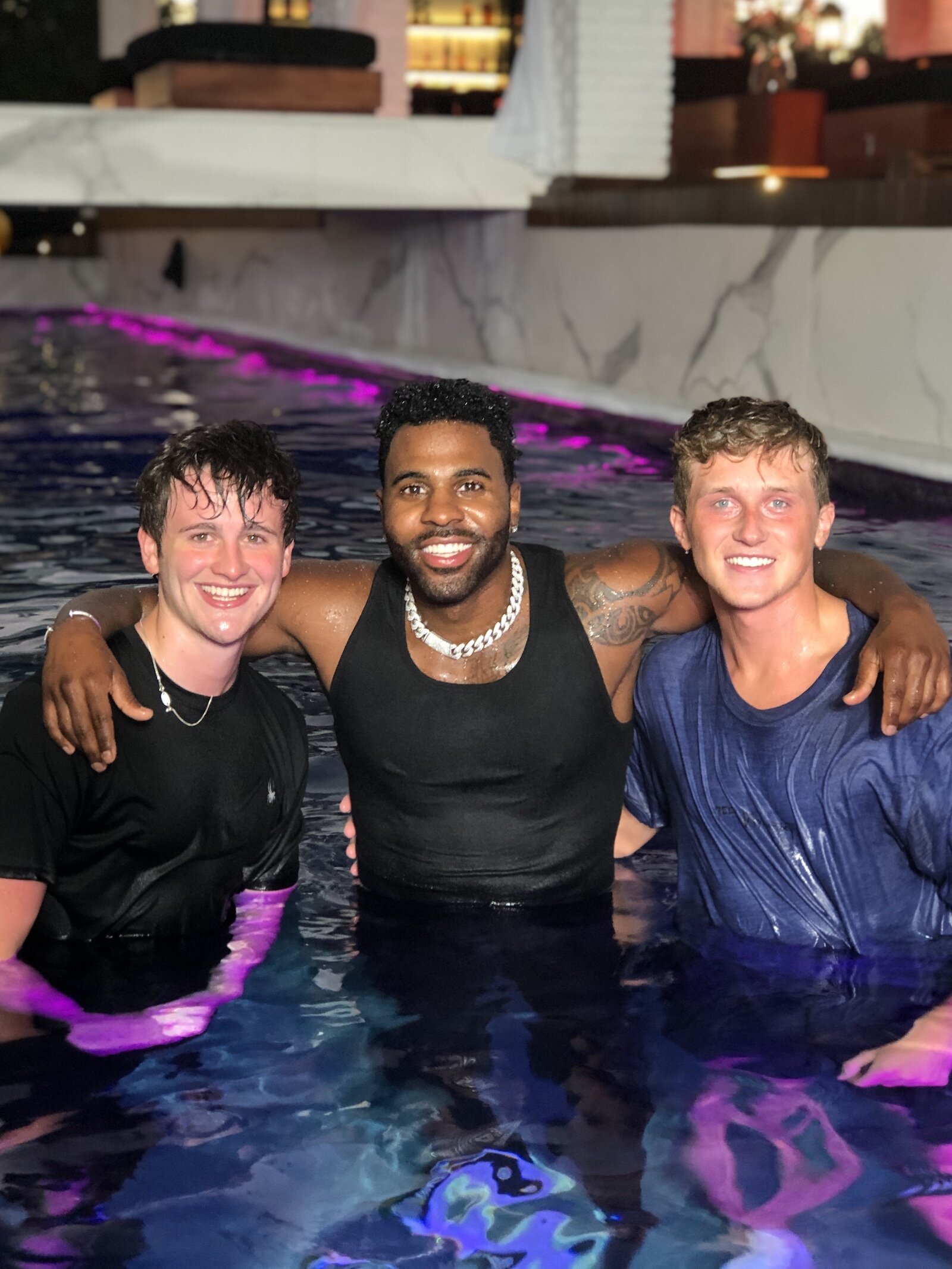 The Cheeky Boyos pose with singer-songwriter Jason Derulo in his Los Angeles pool.