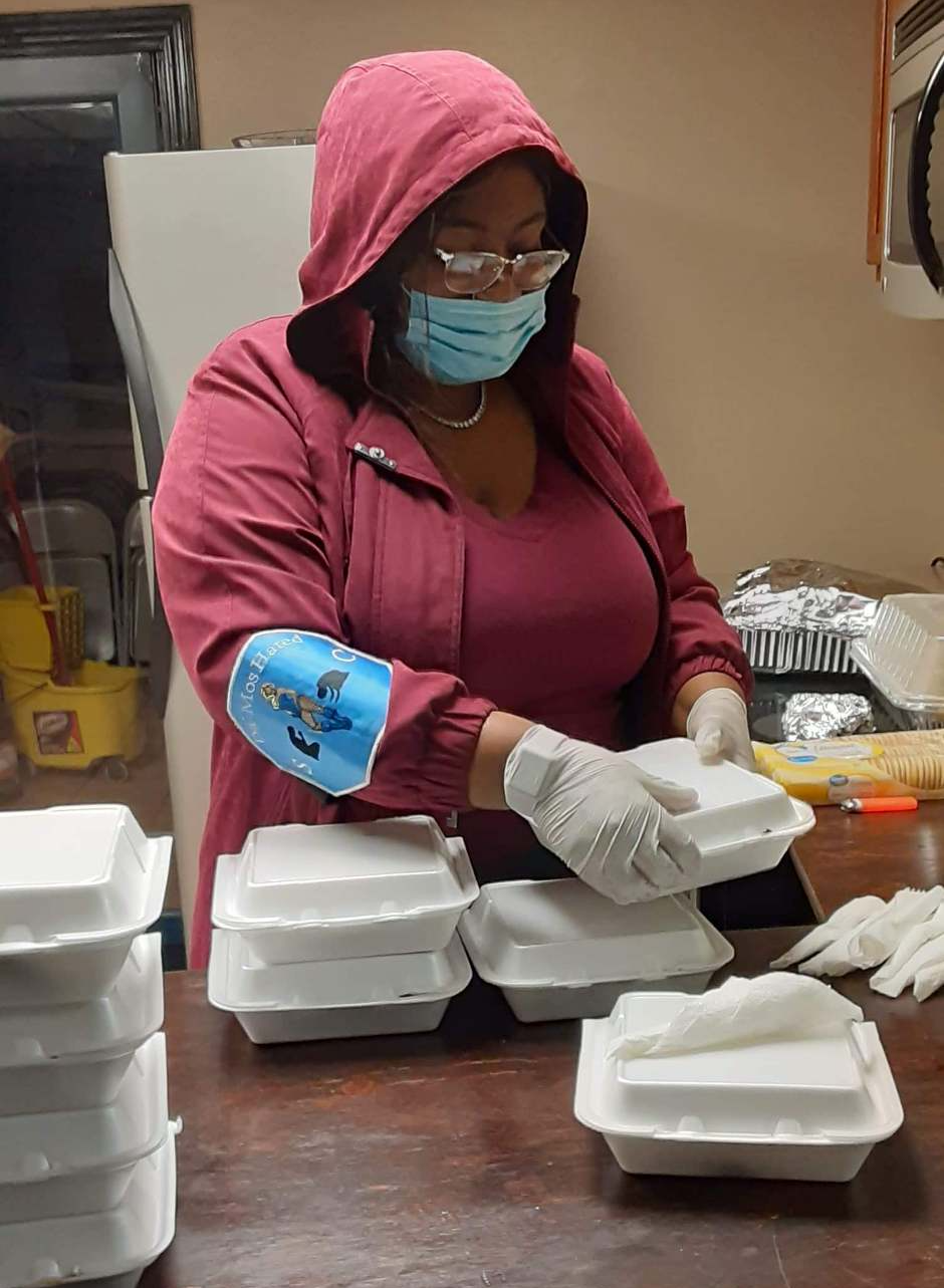 Volunteers package carry out meals for guests at the November curbside giveaway.