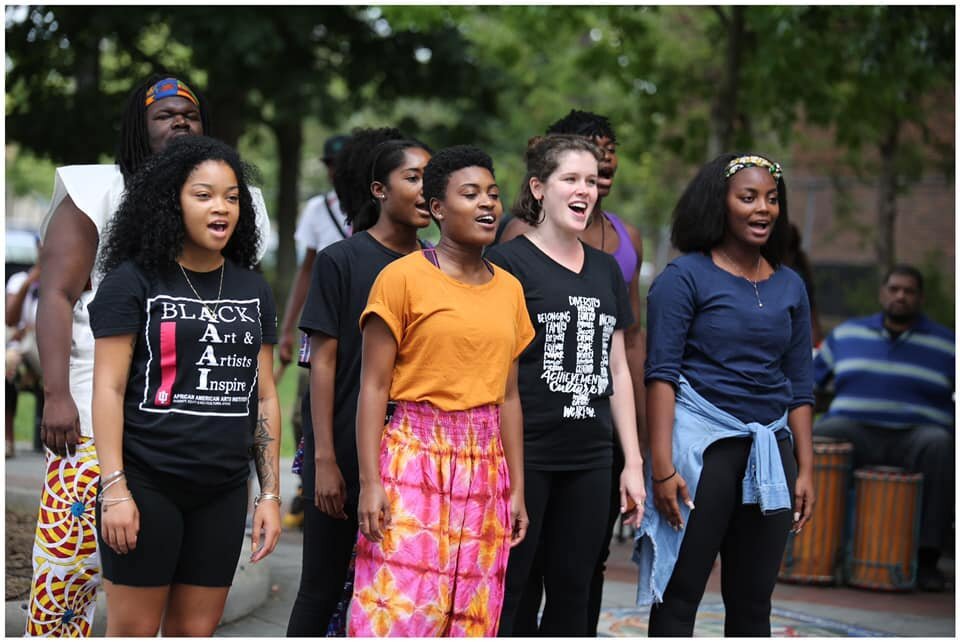 Singers perform in Peoples Park as a part of āKuadhimishaā in September 2019.