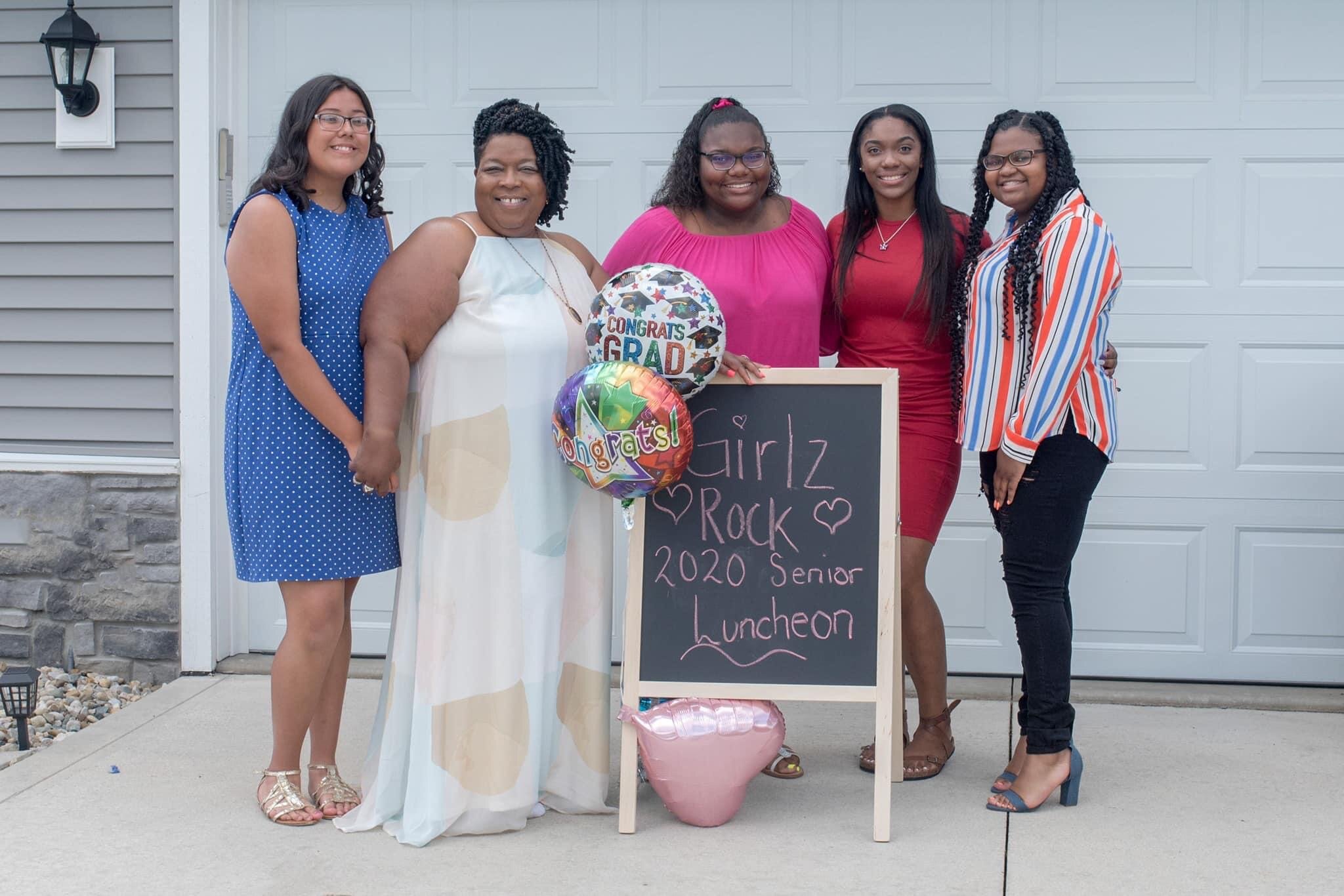 Washington, second from left, hosted a ceremony for her Girlz Rock seniors at her home in 2020.