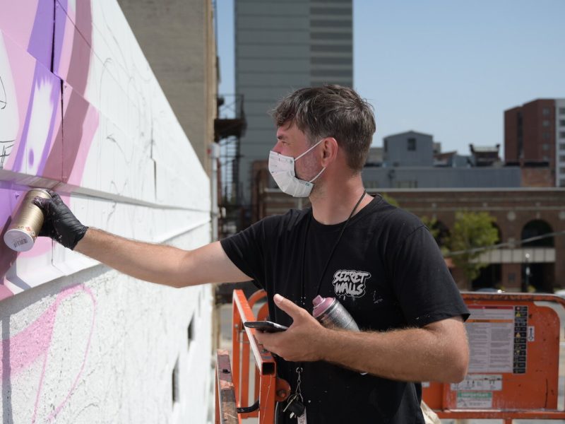 Key Detail works on a mural in downtown Fort Wayne.