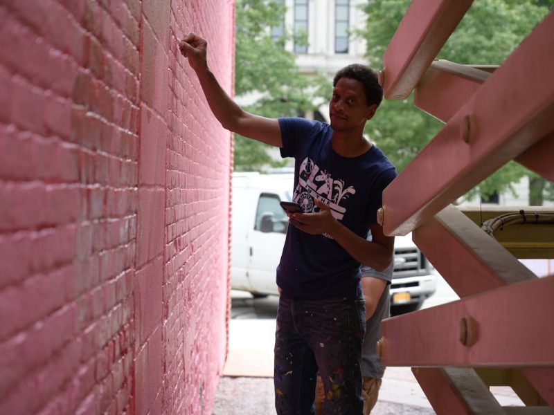 Shawn Dunwoody works on a mural in downtown Columbia City.