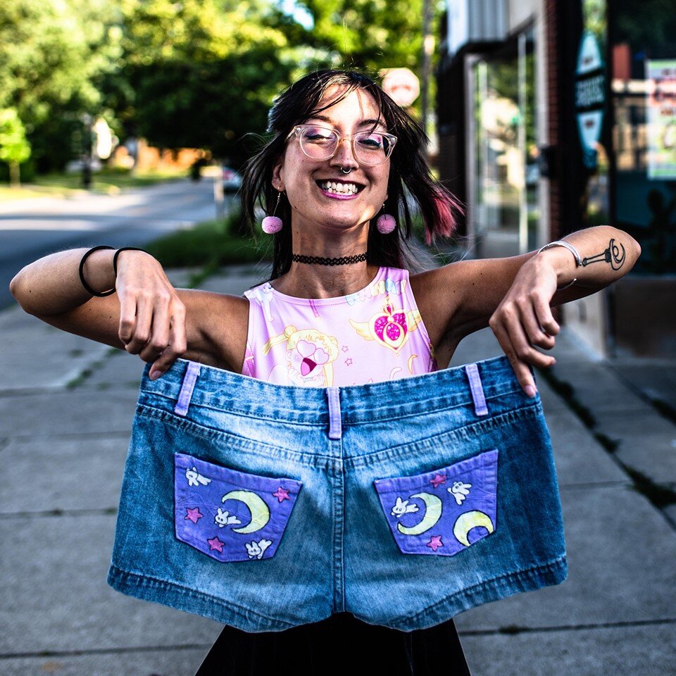 Debbi Kuntz displays painted jeans she created.