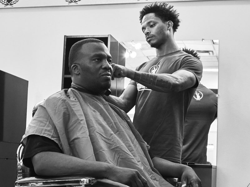 Mark Vachon styles Big Kess's hair at the new iMack Barber Lounge.