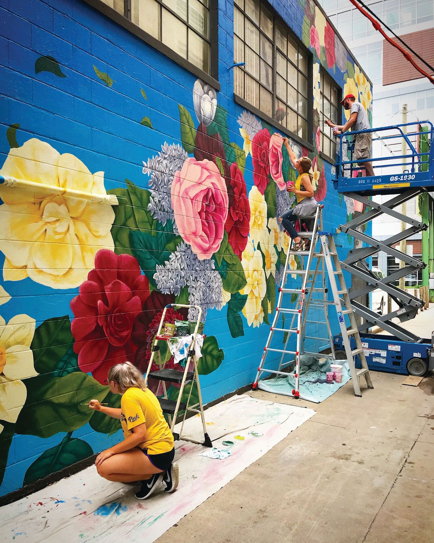 A previously painted mural of Walt Whitman in progress in downtown Fort Wayne.