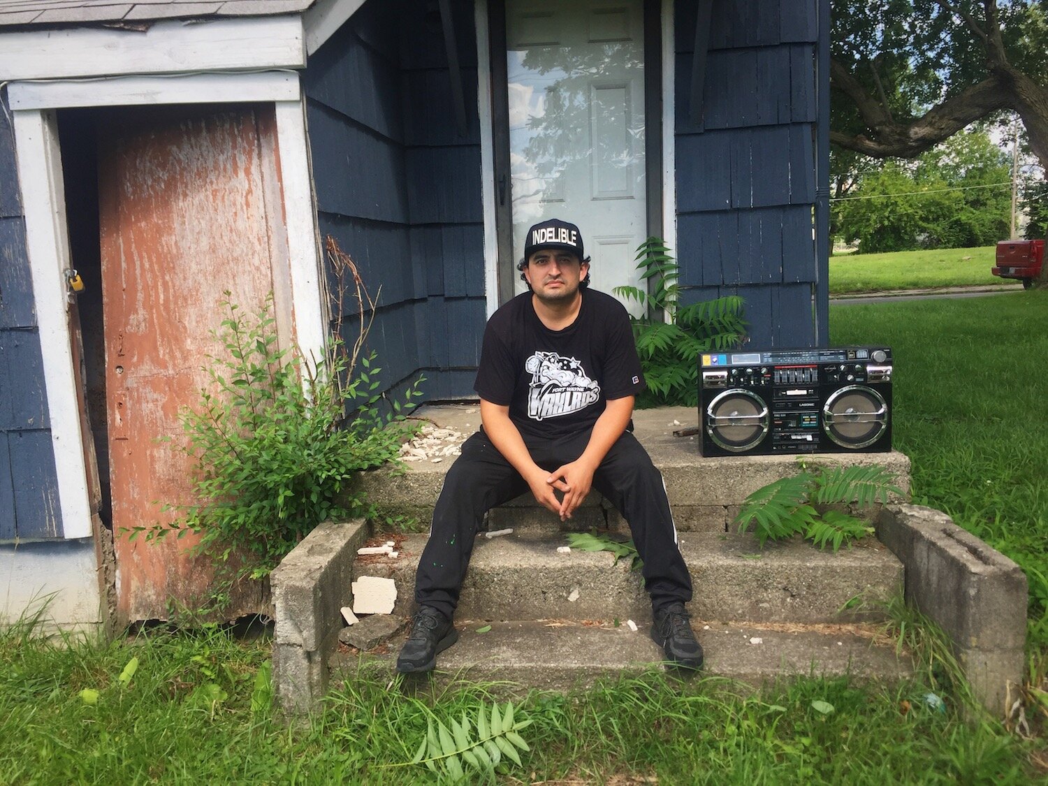 Francisco Reyes sits on the back porch of his house in Southeast Fort Wayne.