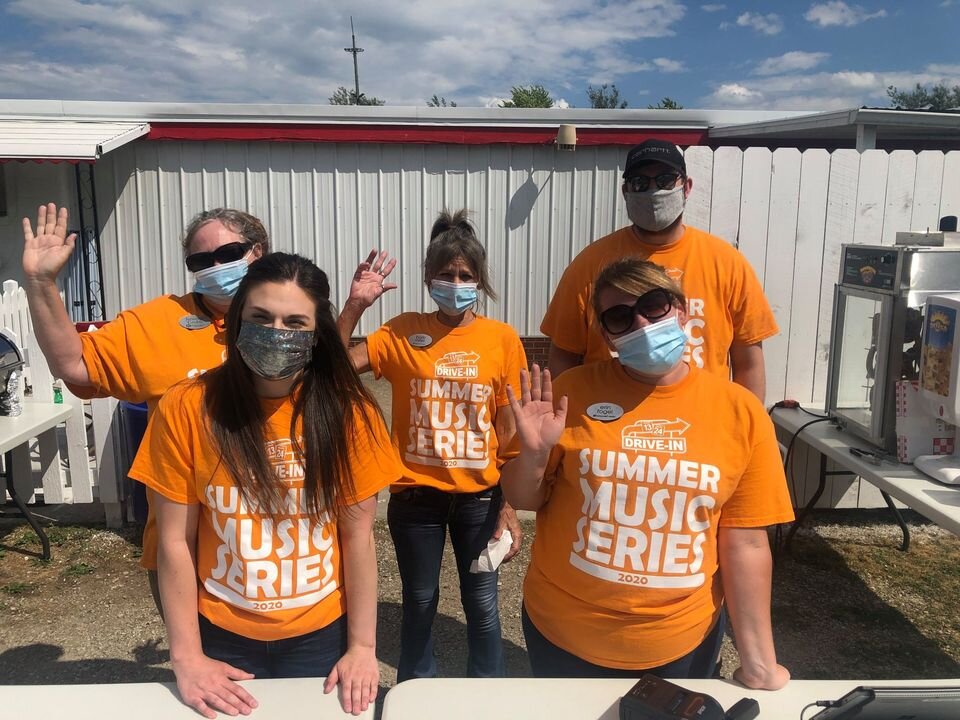 Workers at the 13-24 Drive-In wear masks.