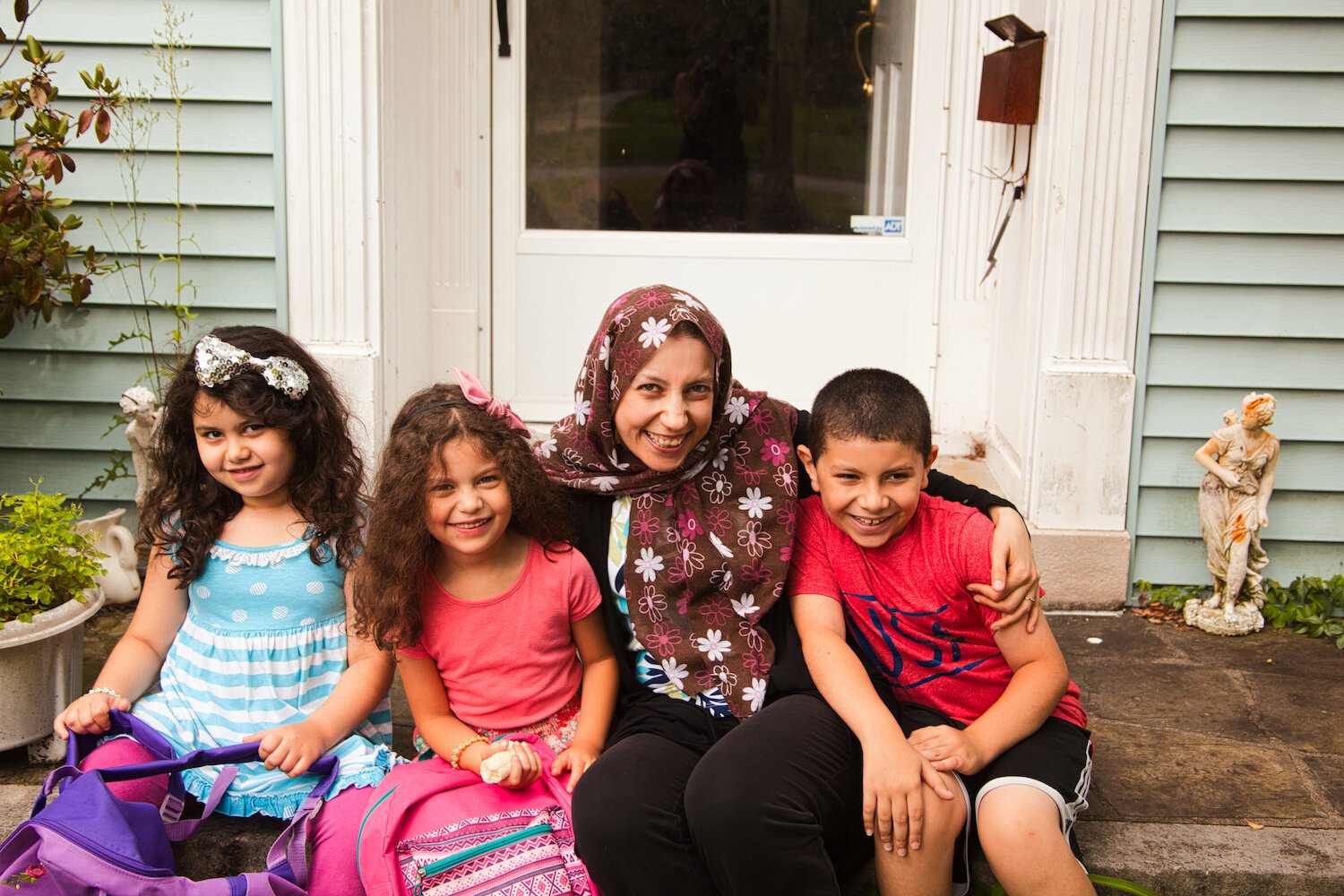 Sabreen Taqateq, a mom and assistant teacher, with her three children, Jamal, Tuleen, and Talia.