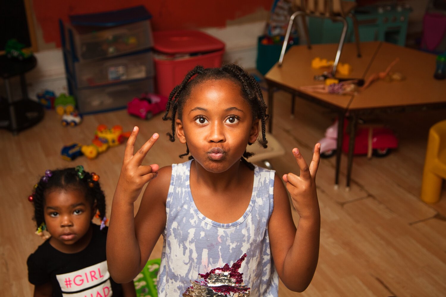 Kenyale Bryant, Smiley's daughter, poses in front of the school room at the end of the child care day.