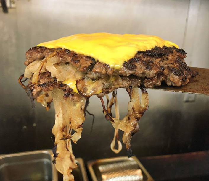 A Fried Onion Burger in the making.