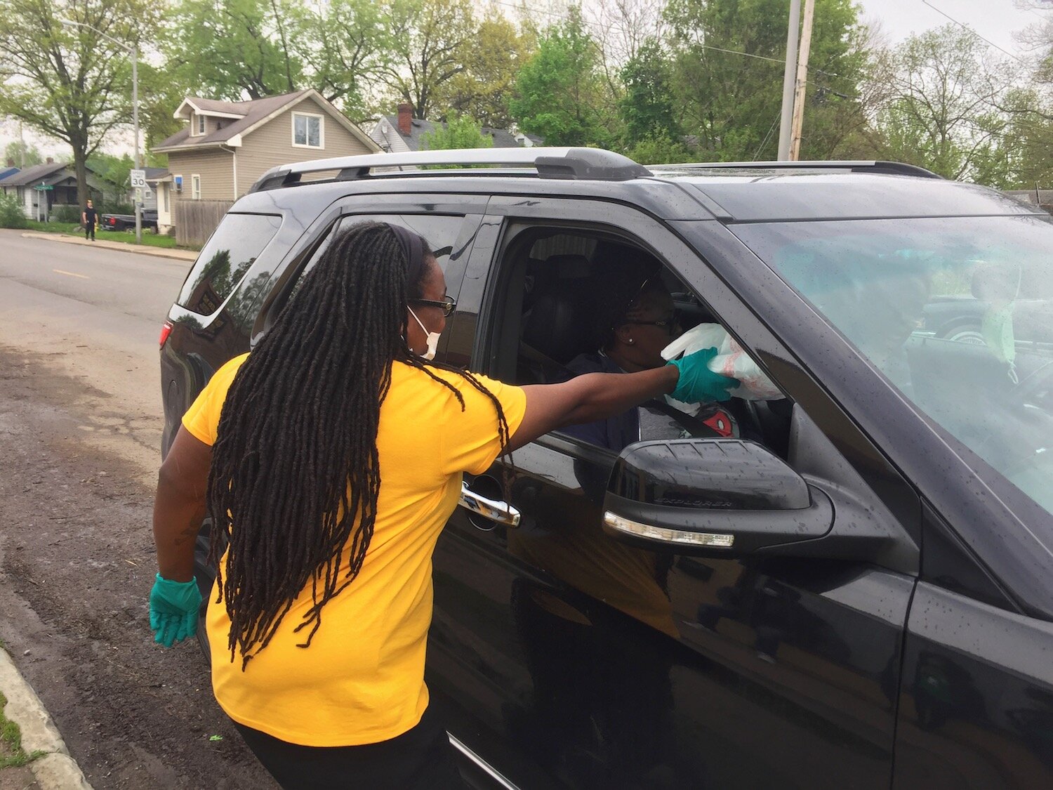 Greene hands out bags of food and supplies at the Curbside BBQ.