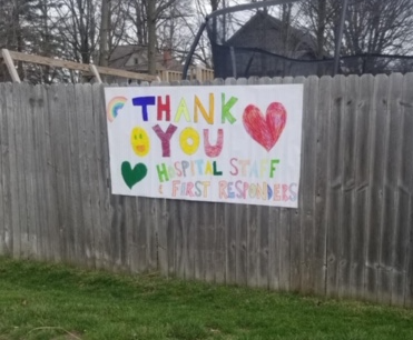 LaGrange neighbors hang "thank you" signs for hospital staff on fences.