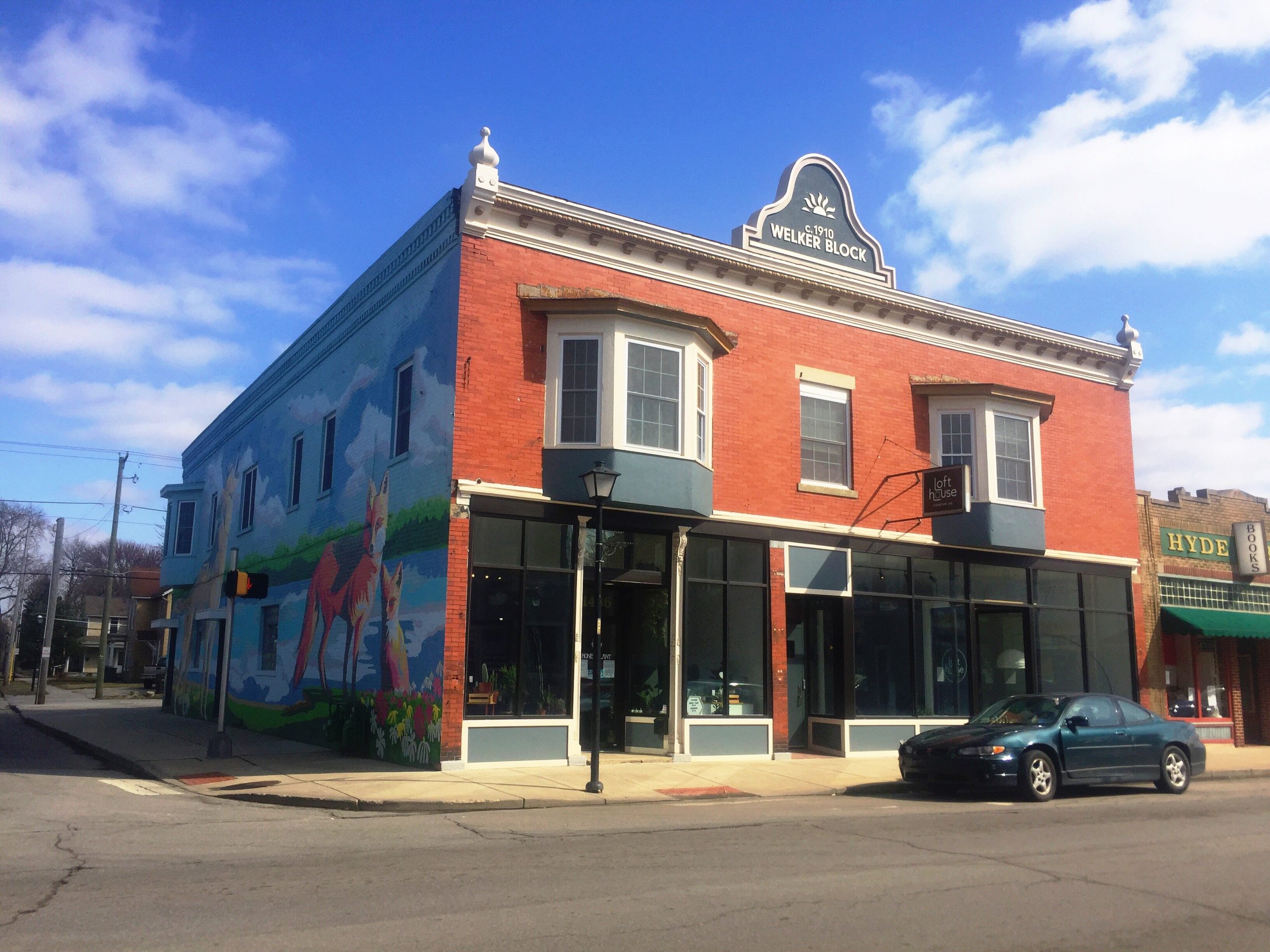 Lofthouse is on the right side of the building, and a shop called the Honey Plant is on the left side.