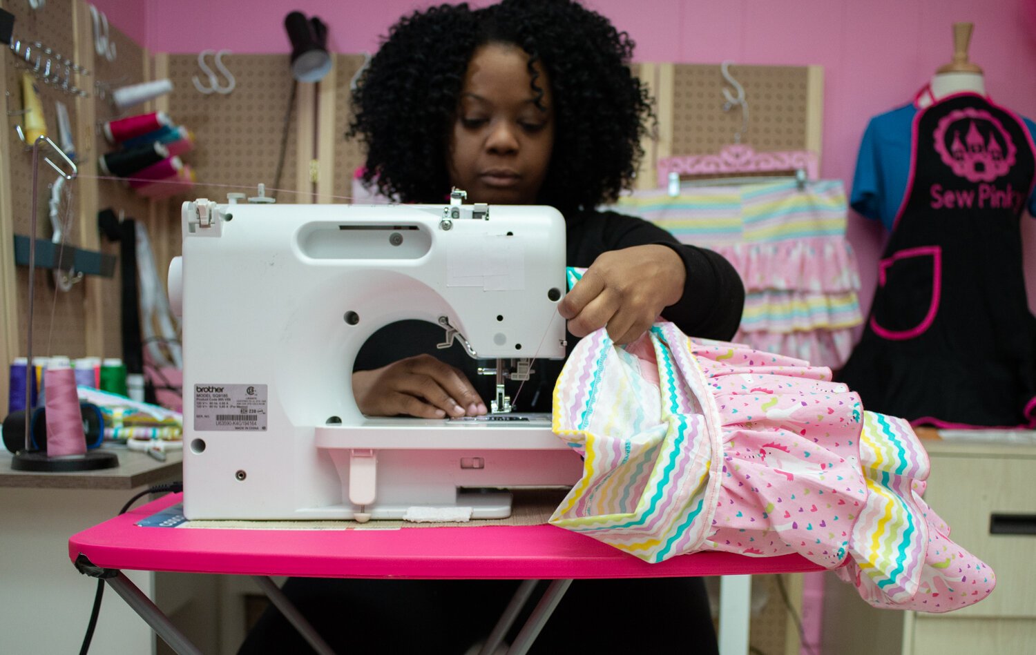 Pinky is a self-taught seamstress who teaches other girls to sew.