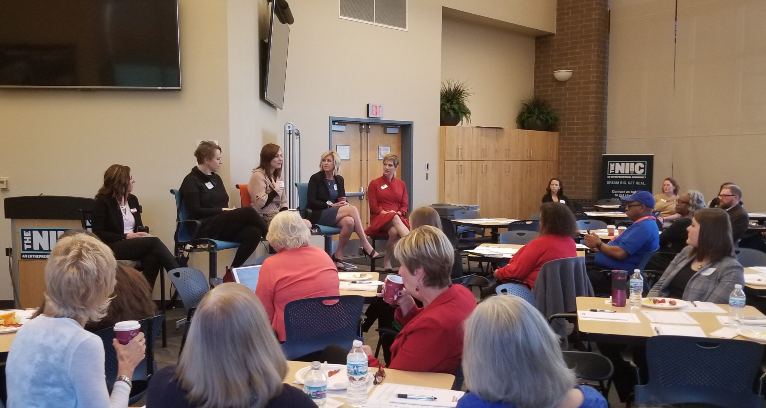 Hill, right, presents on a panel at the NIIC.