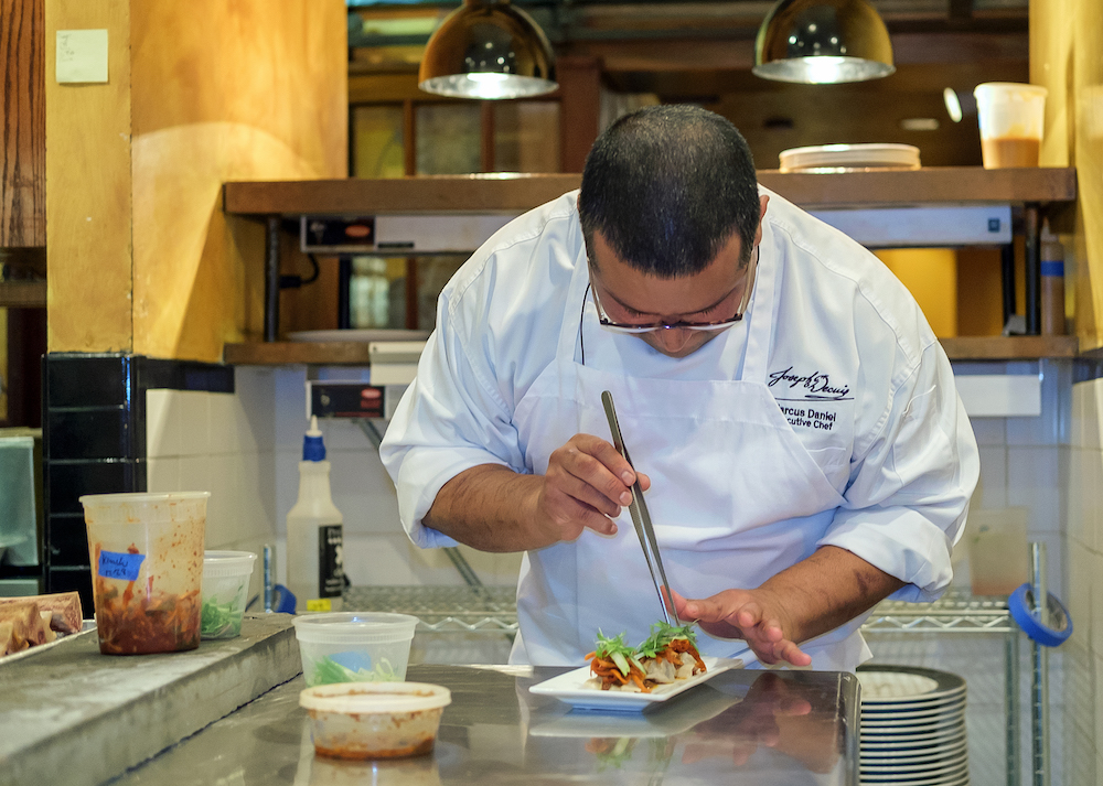 Chef Marcus Daniel prepares a dish.