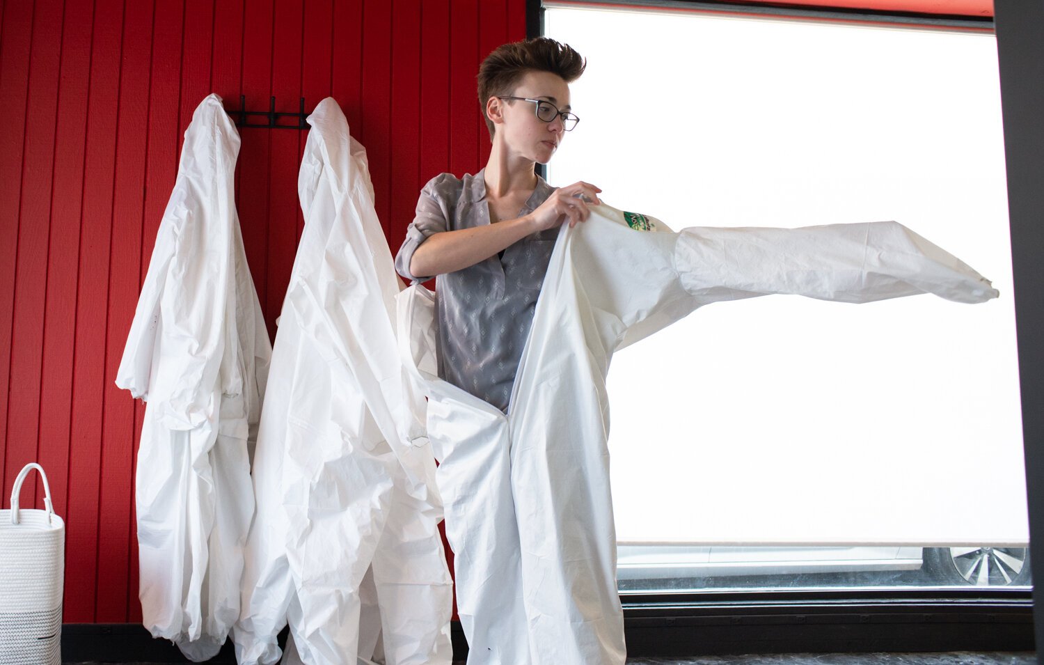 Owner Brianna Dailey puts on a protective suit at All the Rage.