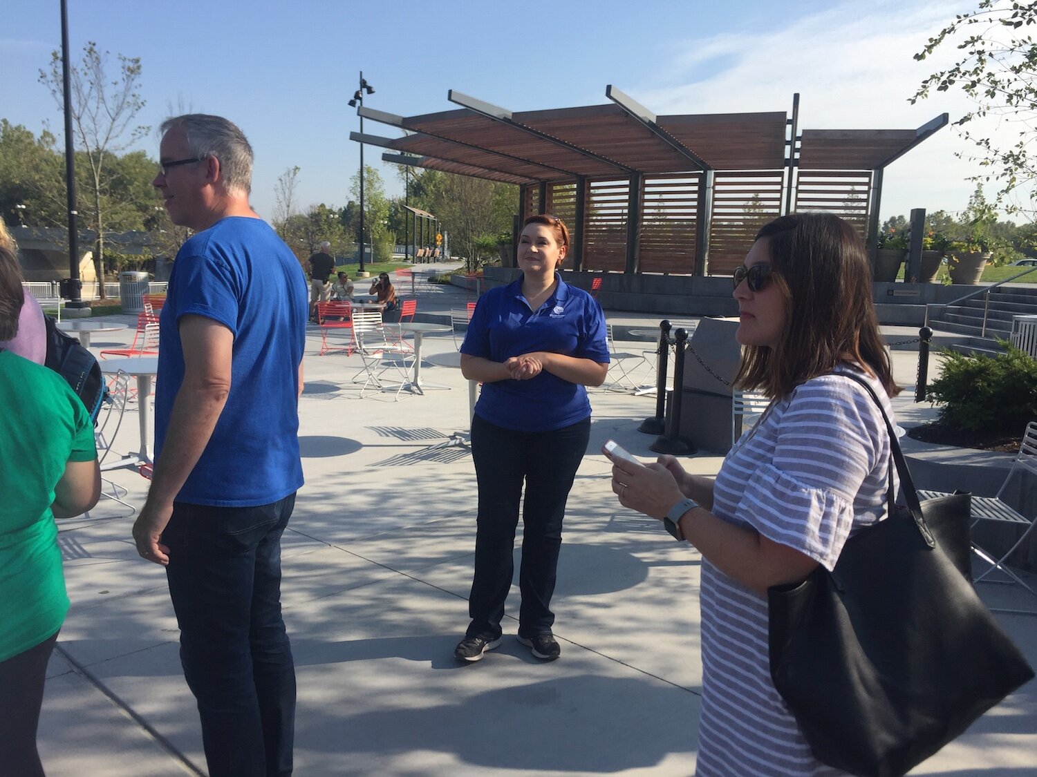 Megan Butler of Riverfront Fort Wayne, center, leads the travel writers through the park.
