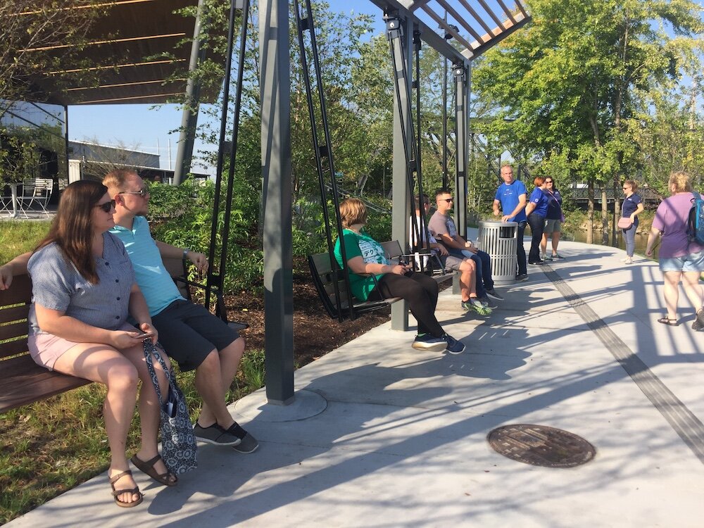 Travel writer Katie Scott of Logansport and her husband test the new swings in Promenade Park.