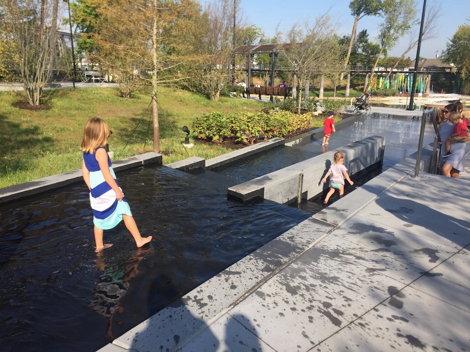 The children of travel writers play in the water features at Promenade Park.
