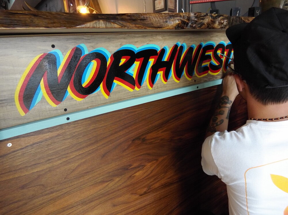 Justin Lim is a sign painter by trade at Old 5 and Dime Sign Co.