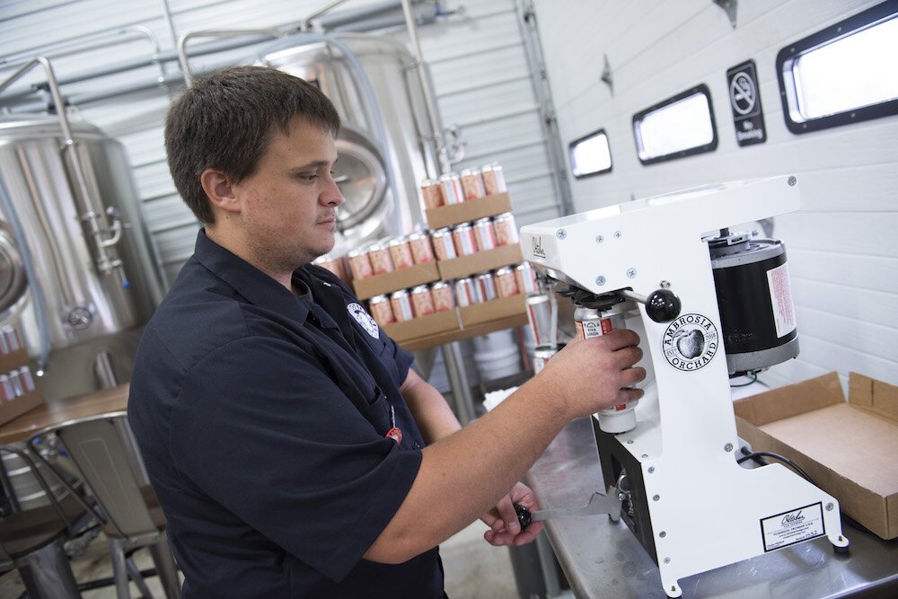 Bender works on cider behind the scenes at Ambrosia Orchards.