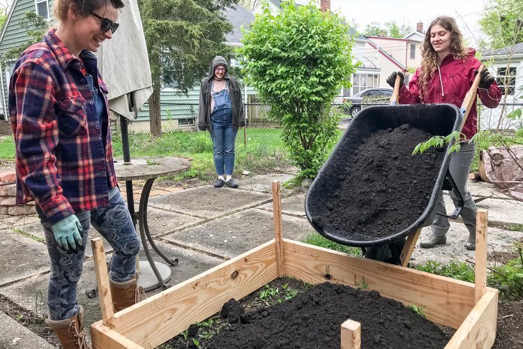 Neighborhood volunteers build a community garden.