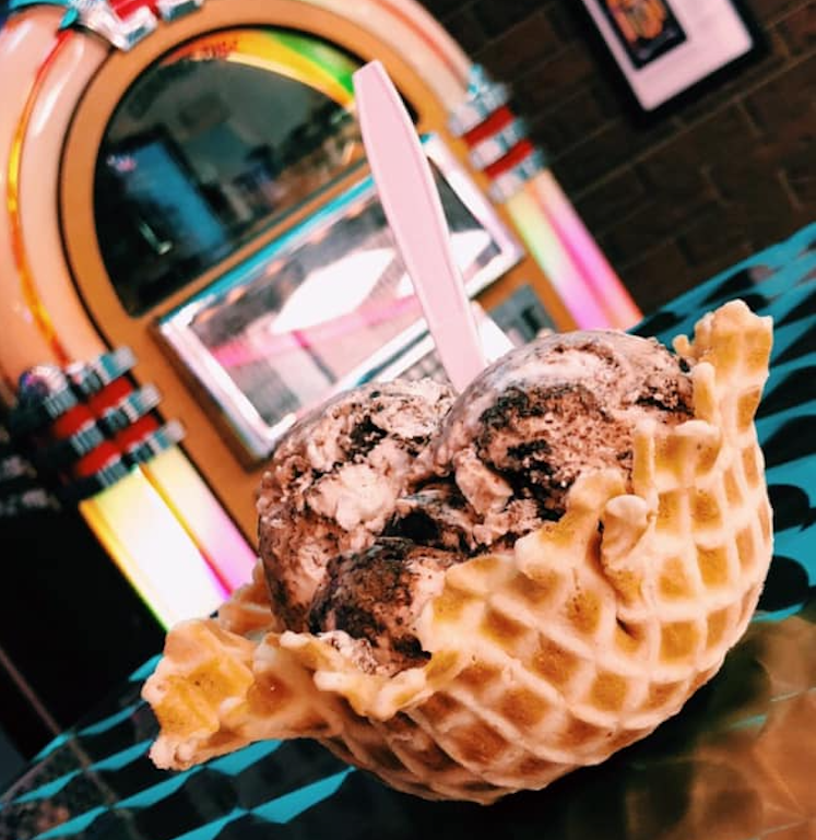 The Eskimo kisses ice cream at Jukebox Ice Cream Parlor is a creamy coconut ice cream with thick chocolate fudge and chocolate truffles in a homemade waffle bowl.