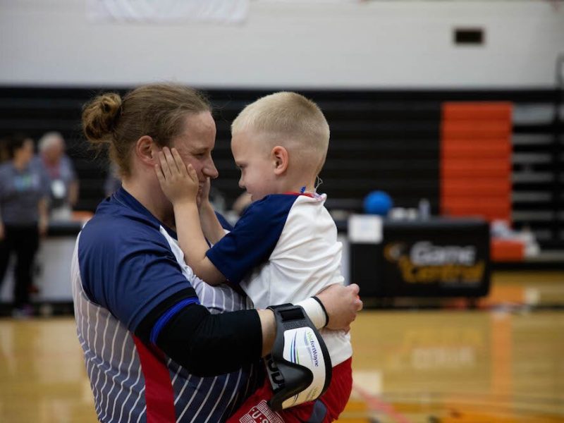 Lisa Czechowski, a member of the qualifying USA women’s goalball team, celebrates with her son.