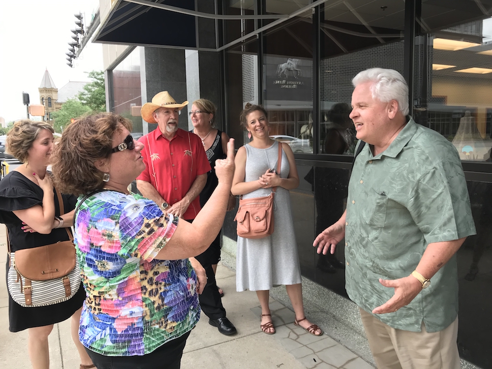 Harter, right, jokes with guests on a Saturday food tour.