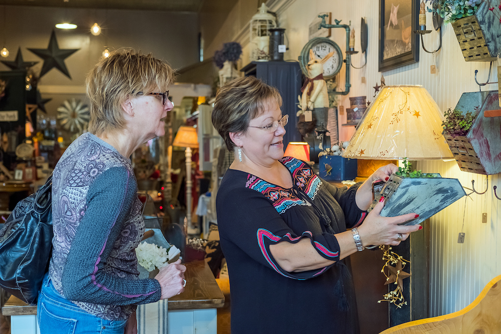 Boggs shows an item to a curious customer.