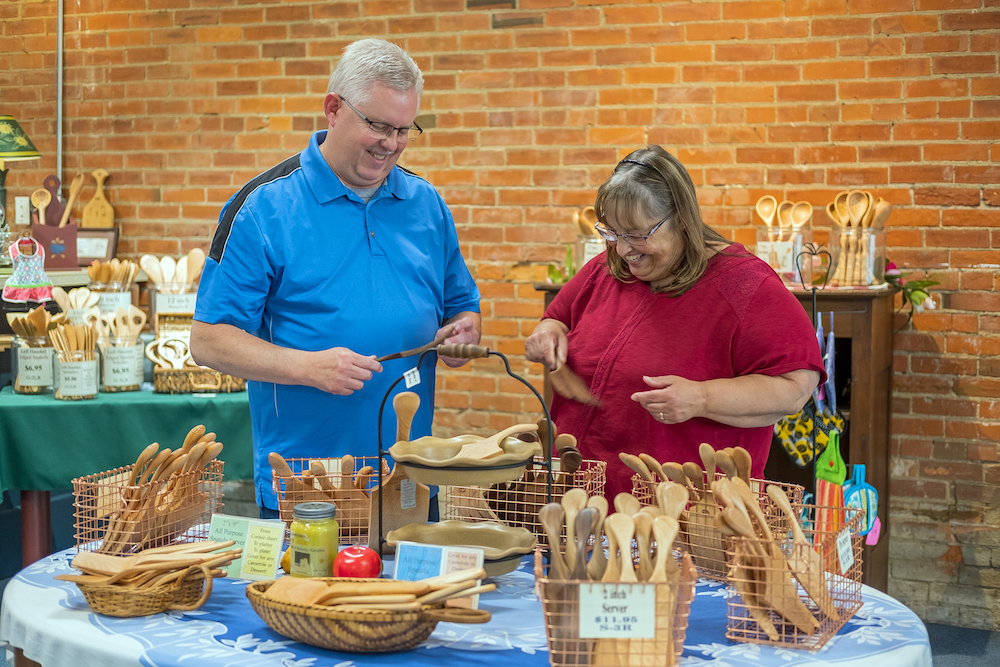 Customers Kevin and Crystal Stiverson from Leo browse the kitchen utensils at Whetstone Woodware.