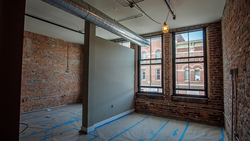 Exposed brick and open layouts are key features of the Artist Lofts's living spaces.