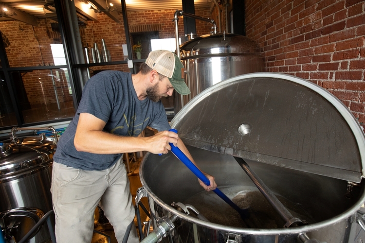 Cofounder and head brewer Jesse Sensenig works on a new batch of beer.