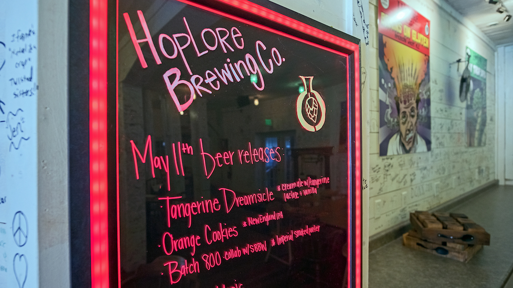 Customers write on the wall at HopLore Brewing, adding to its ambiance.