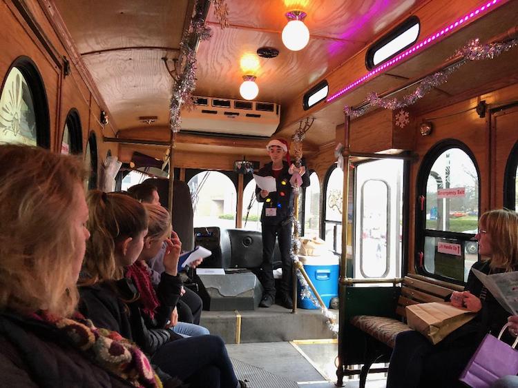 Noah Johnson speaks on a Holly Trolley Tour among downtown shops.