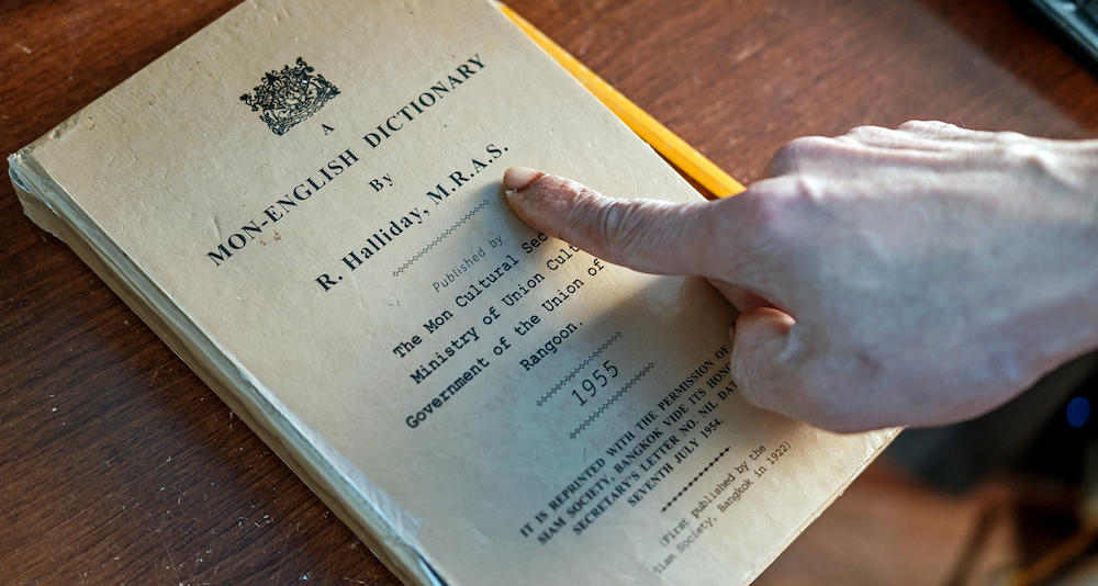 Sac Lun uses a Mon-English Dictionary for reference.