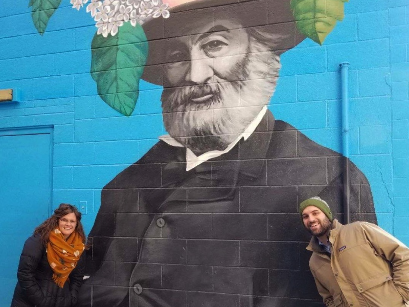 Amanda Golden and Josh Lapp of Designing Local pose in front of Tim Parsley's Walt Whitman mural in downtown Fort Wayne.