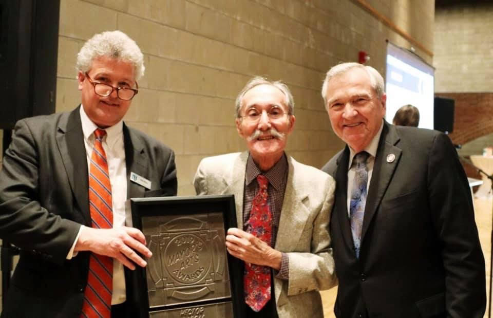The sculptor Hector Garcia, center, received the Mayor's Arts Award from Arts United in 2019. (Photo by Daniel Church)
