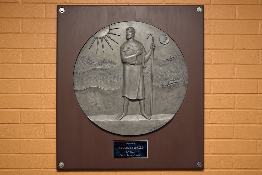 Garcia's “The Good Shepherd” plaque (2009) is at the entrance of the Rescue Mission.