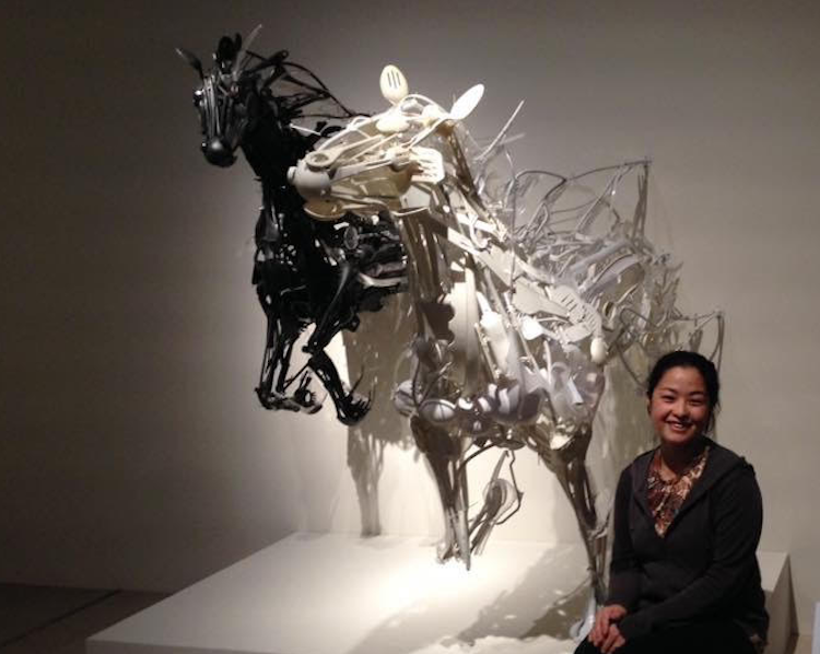 Artist Sayaka Ganz poses by "reclaimed creations" sculptures she has made from recycled plastics.