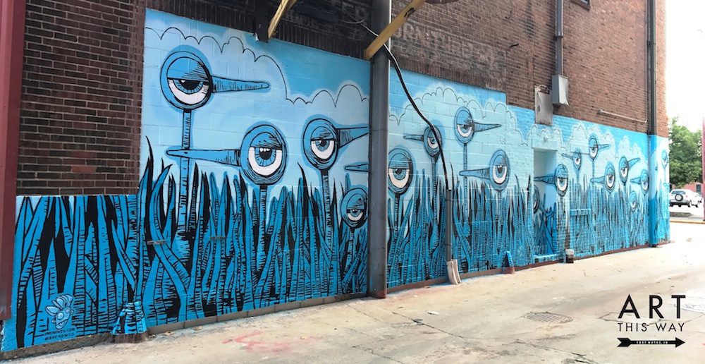 Artist Bryan Ballinger painted a mural on the side of the Ambassador Enterprises building at 927 Harrison St.