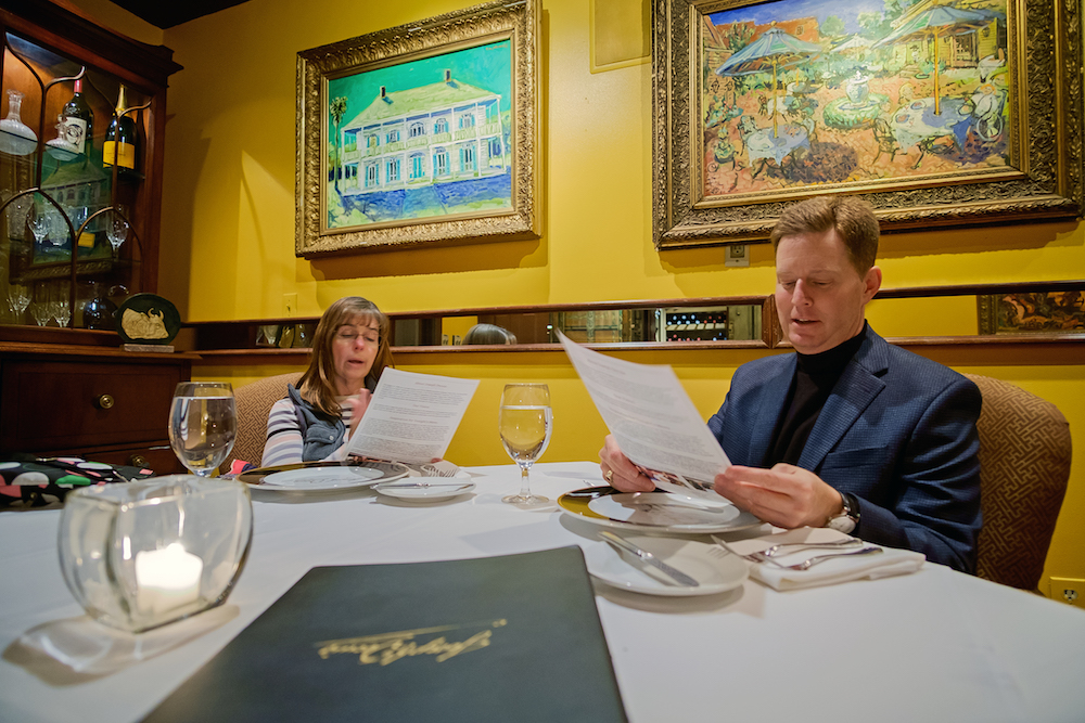 Patrons browse the menu at Joseph Decuis restaurant.