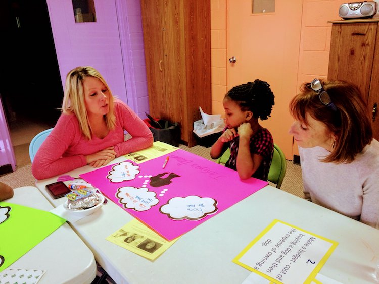 Volunteers work with students at Wonderfully Made.