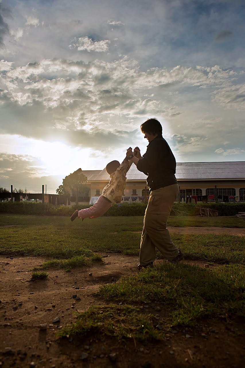 Denise Walsh plays with children outside the orphanage.