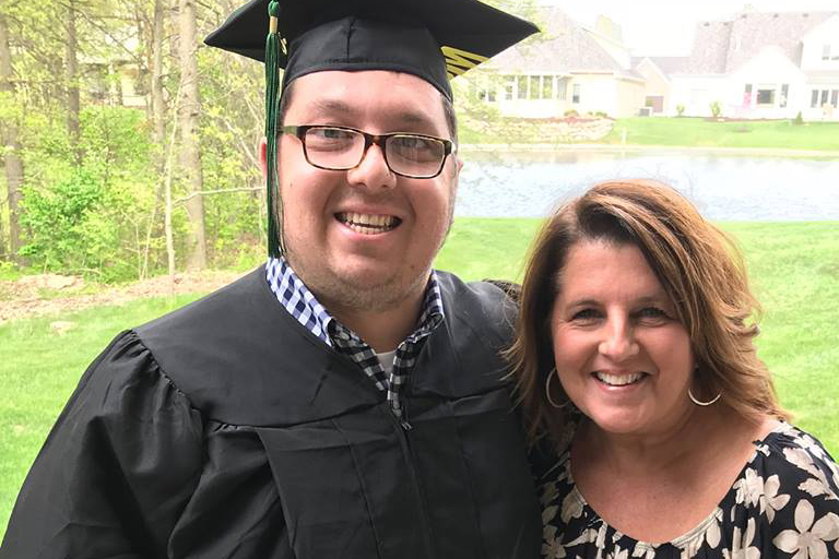 Mossburg and his mother celebrate his graduation.